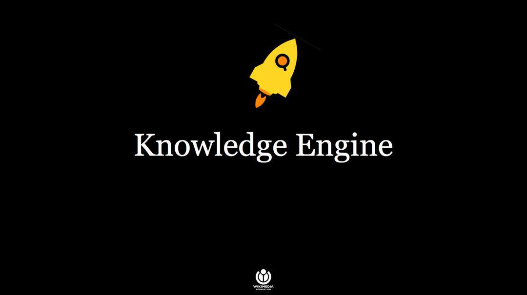 Opening slide to a presentation. Text reads 'Knowledge Engine', underneath is a vector graphic of a rocket.